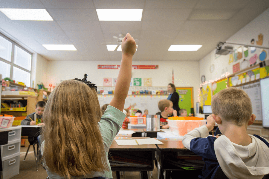 young kids in a classroom practicing lockdown drills for their safety